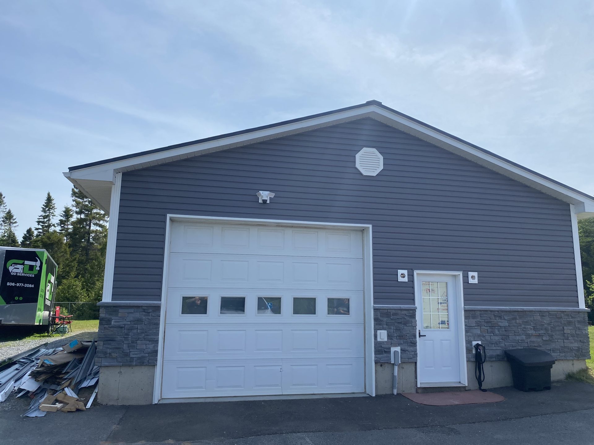 After — garage siding and stone completed by GD Outdoor Services